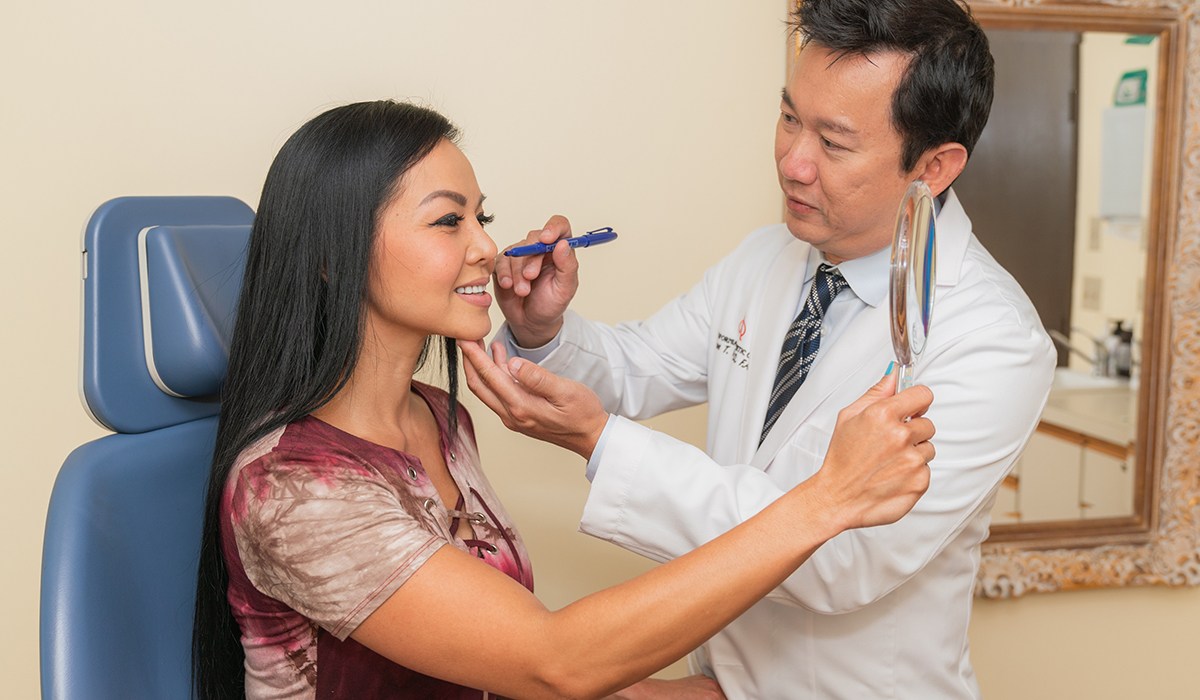 Dr Vu Using Marker On Female Patients Face During Consultation's Face During Consultation