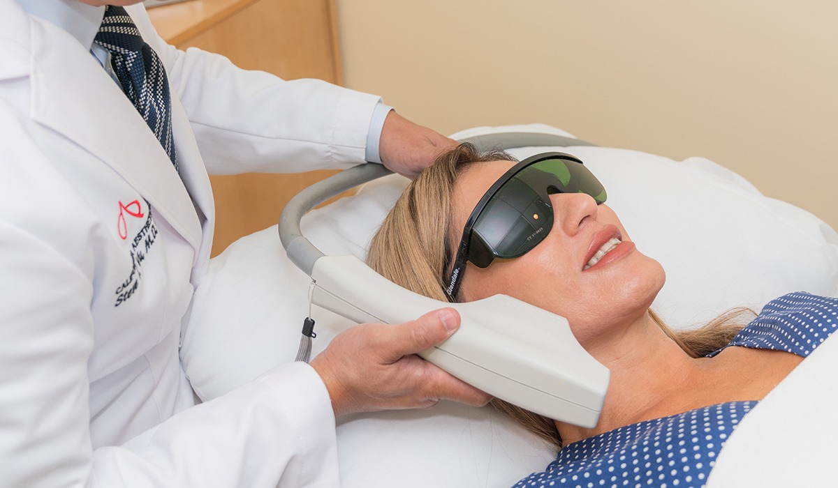 Dr Vu Using Photofacial Device on Female Patients Face While She Wears Protective Eyewear's Face While She Wears Protective Eyewear